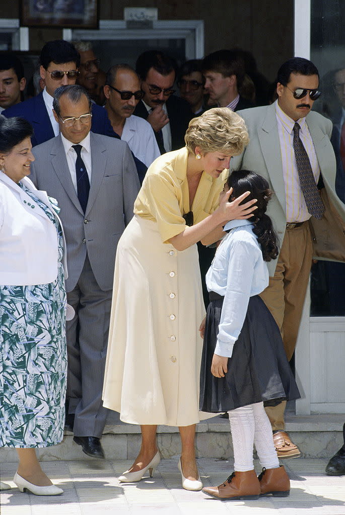 Diana cuddles 10-year-old Heba Salah while visiting The Institute for Polio Rehabilitation in Cairo, Egypt. <em>(Photo by Tim Graham/Getty Images)</em>