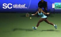 Serena Williams of the U.S. plays a shot against Ana Ivanovic of Serbia during their WTA Finals singles tennis match in Singapore October 20, 2014. REUTERS/Edgar Su