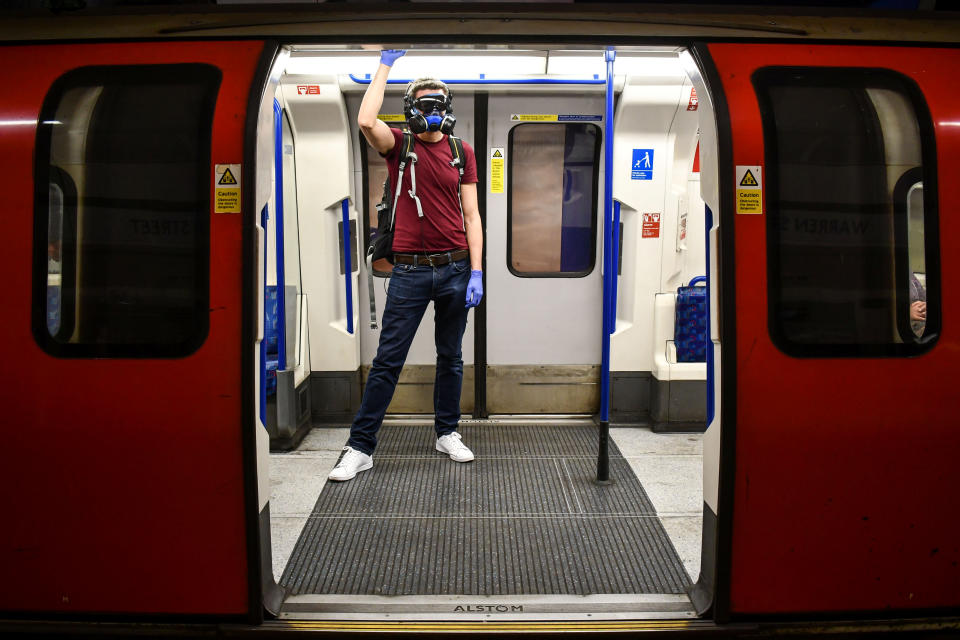 A single commuter rides a deserted Tube train.