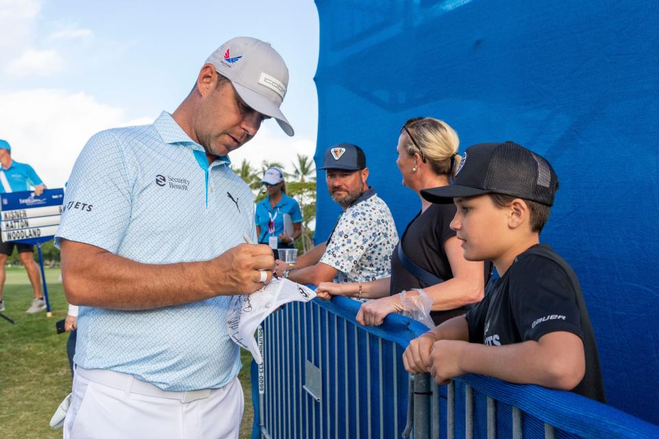 January 12, 2024; Honolulu, Hawaii, USA; Gary Woodland signs an autograph for a fan during the second round of the Sony Open in Hawaii golf tournament at Waialae Country Club. Mandatory Credit: Kyle Terada-USA TODAY Sports