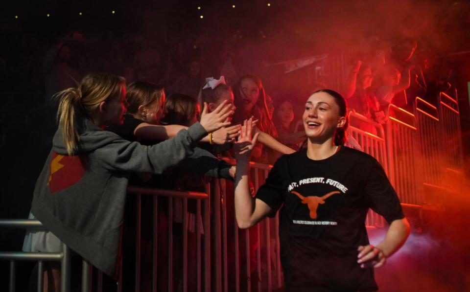 Texas Longhorns guard Shay Holle (10) gives out high-fives as she takes the court ahead of the Texas Longhorns' game against the Texas Tech Red Raiders at the Moody Center in Austin, Texas, Feb. 21, 2024. Texas won the game 77-72.