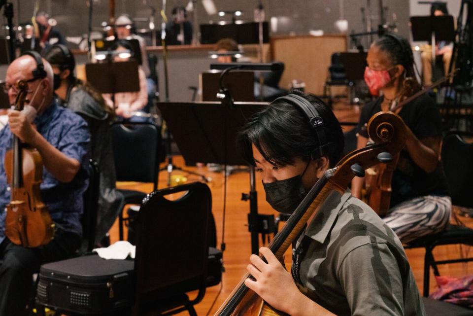 Students recording a song on the soundstage.