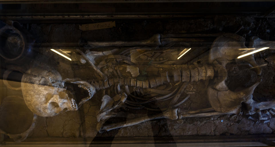 A man skeleton found in the 19th century in the Roman Forum is on display in a glass case at the Forum in Rome, Wednesday, April 19, 2023. The piece, today on display at the Forum, dates back to the 10th century B.C and was part of the myriads of findings still kept in the Colosseum storehouse that is not open to the public. (AP Photo/Domenico Stinellis)