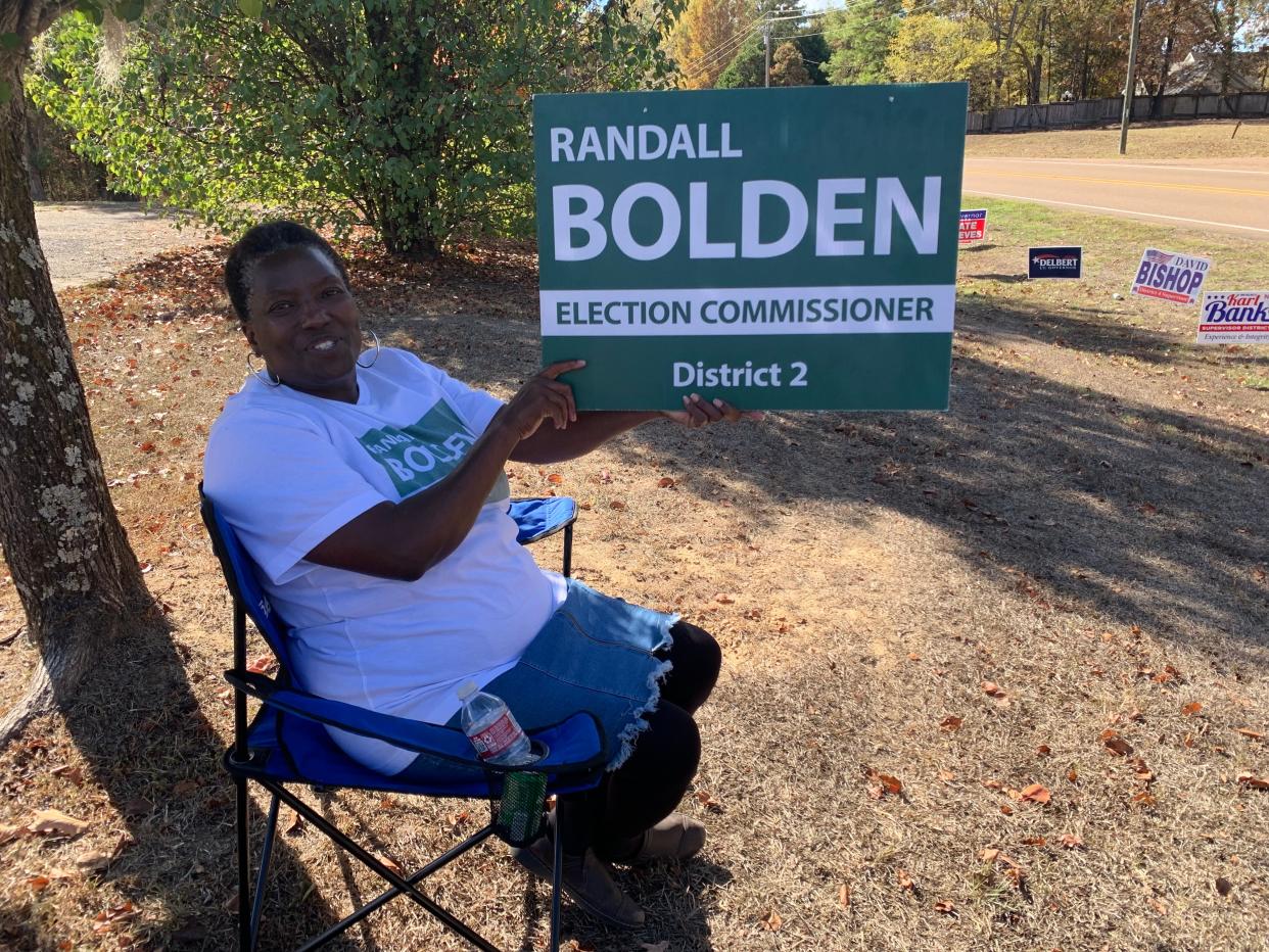 Linda Bennett sits outside China Grove Church in Madison holding a sign for District 2 Election Commissioner candidate Randall Bolden on Nov. 7.