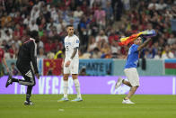 A pitch invader runs onto the pitch with a rainbow flag during the World Cup group H soccer match between Portugal and Uruguay, at the Lusail Stadium in Lusail, Qatar, Monday, Nov. 28, 2022. (AP Photo/Themba Hadebe)