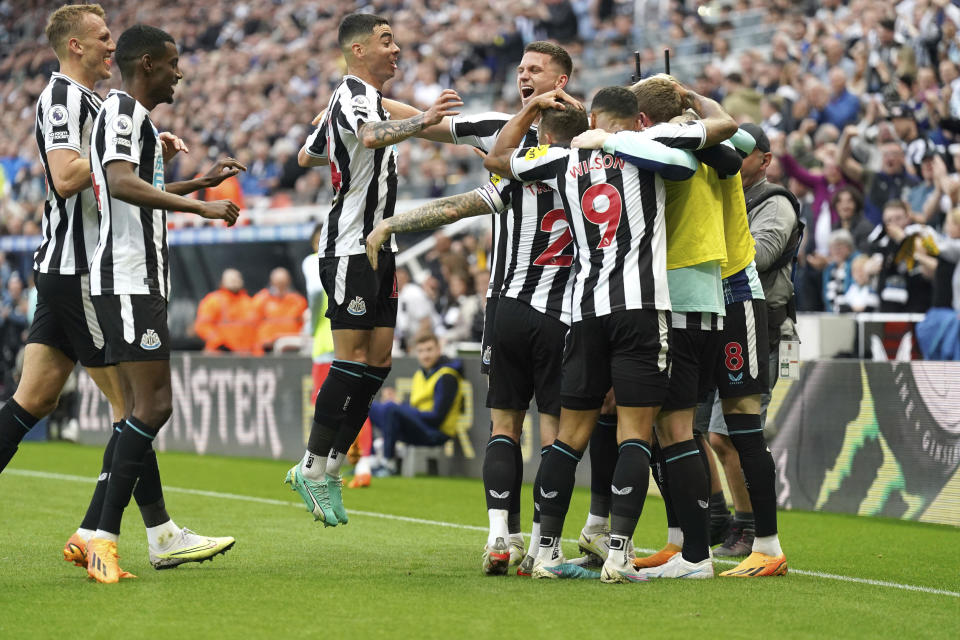 Newcastle United celebrate after Brighton and Hove Albion's Deniz Undav scores an own goal during the English Premier League soccer match at St. James' Park, Newcastle, England, Thursday May 18, 2023. (Owen Humphreys/PA via AP)