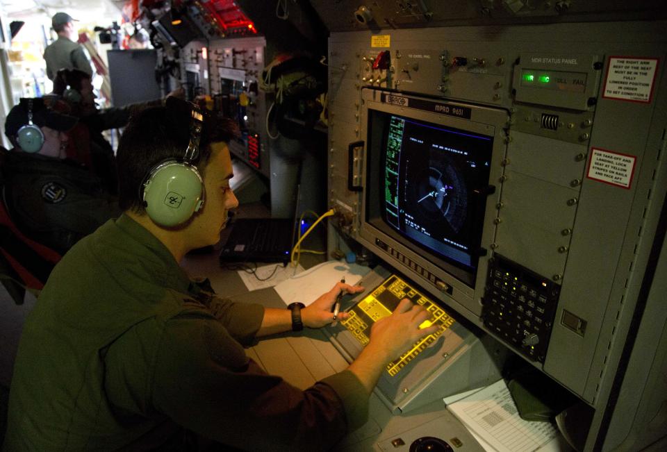 FILE - In this Thursday, March 27, 2014, file photo, Sgt. Matthew Falanga, an airborne electronics analyst, observes a radar image aboard a Royal Australian Air Force AP-3C Orion aircraft during a search operation of the missing Malaysian Airlines Flight 370 over the southern Indian Ocean. The disappearance of the airplane has presented two tales of modern technology. The public has been surprised to learn of the limitations of tracking and communications devices, which contributed to the plane vanishing for more than two weeks. But the advanced capabilities of some technologies, particularly satellites, have provided hope that the mystery won't go unsolved. (AP Photo/Michael Martina, Pool, File)