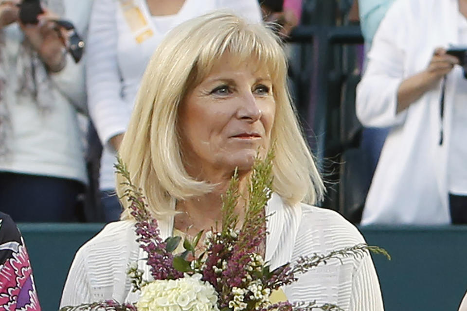 FILE - In this April 7, 2012, file photo, Valerie Ziegenfuss, one of the original nine women who helped start the women's professional tennis tour, is honored at the Family Circle Cup tennis tournament in Charleston, S.C. It’s the 50th anniversary of Billie Jean King and eight other women breaking away from the tennis establishment in 1970 and signing a $1 contract to form the Virginia Slims circuit. That led to the WTA Tour, which offers millions in prize money. (AP Photo/Mic Smith, File)