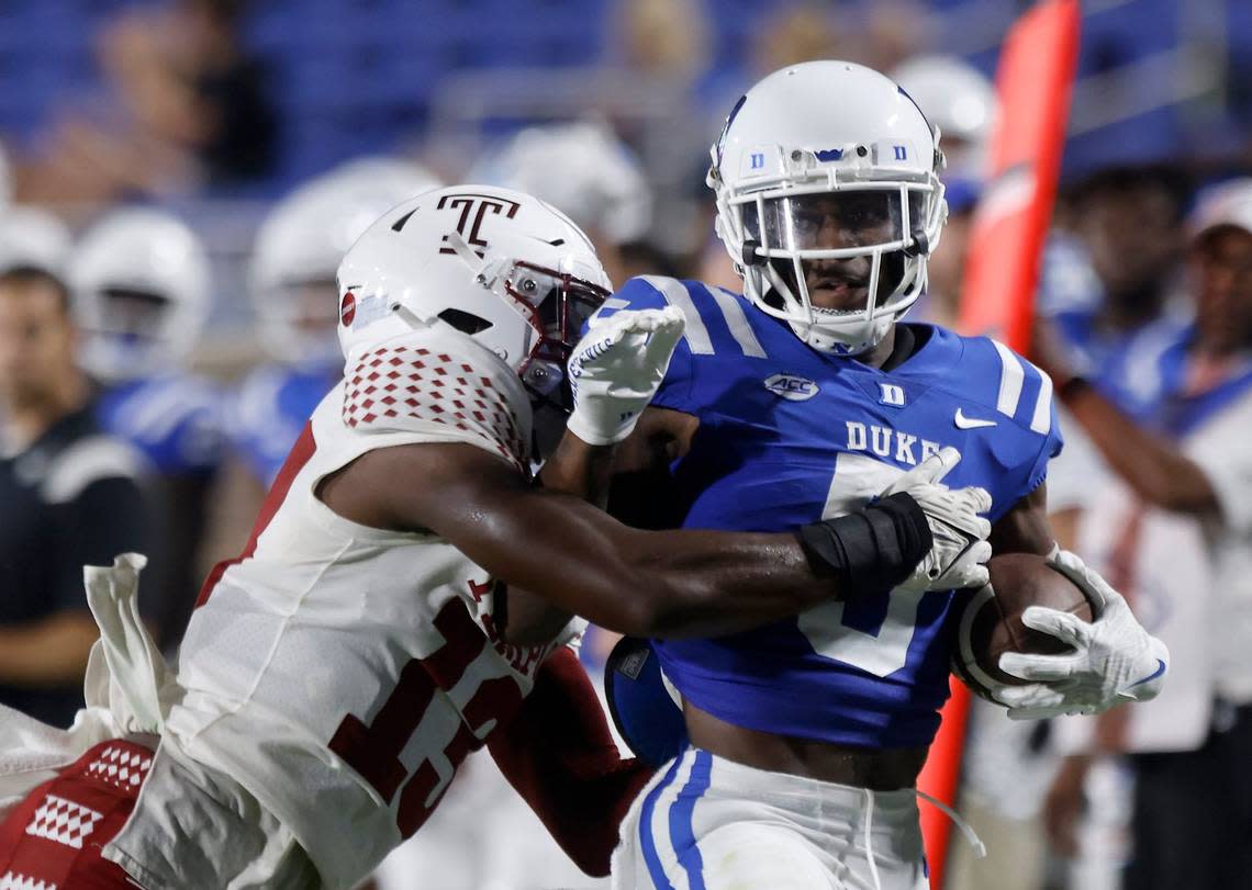 Duke wide receiver Jalon Calhoun (5) runs the ball past Temple linebacker Layton Jordan (13) during the first half of the Blue Devils season opener at Wallace Wade Stadium on Friday, Sept. 2, 2022, in Durham, N.C.