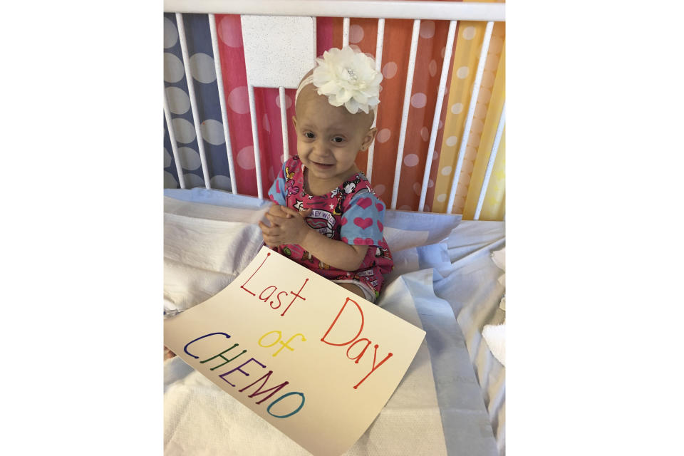Giada Demma, 1-year-old, sits in a pediatric hospital bed at NYU Langone Medical Center in New York on Oct. 17, 2017, the last day she was scheduled to undergo chemotherapy for cancer. Her family had a seamstress make the Disney hospital gown Giada is wearing. But seeing the child wearing a drab hospital issued-gown on a different date helped inspired Giada’s cousin Guiliana Demma to learn to sew and make brightly colored, kid-themed hospital gowns for hospitalized children. Since 2021, Giuliana Demma and her sister Audrina have made and donated 1,800 hospital gowns and several hundred kid-sixed pillows to children in hospitals in 36 states and Uganda. (Melissa Demma via AP)