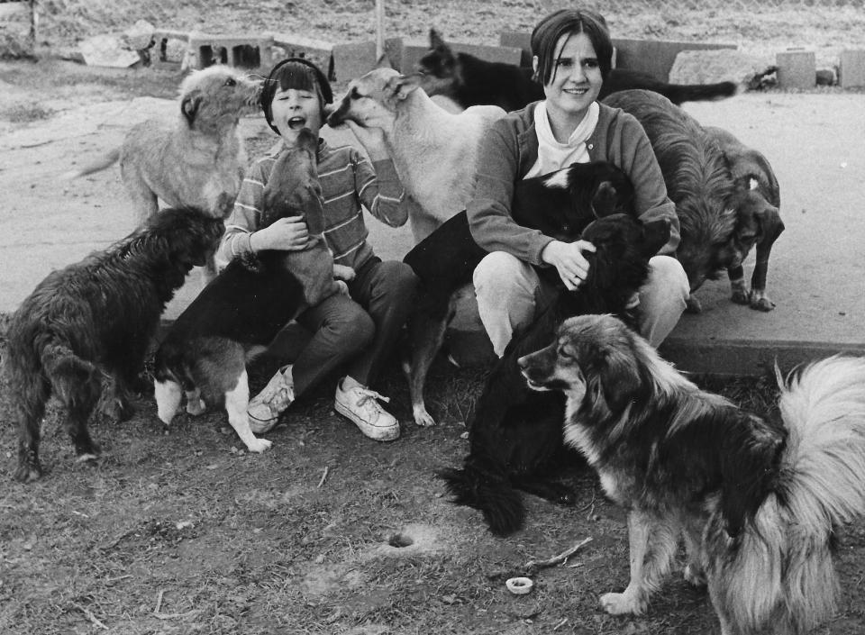 Animal activist Nellie Shriver and her stepson, David, pet some furry friends in 1970 outside their Madrid Drive home in Akron.