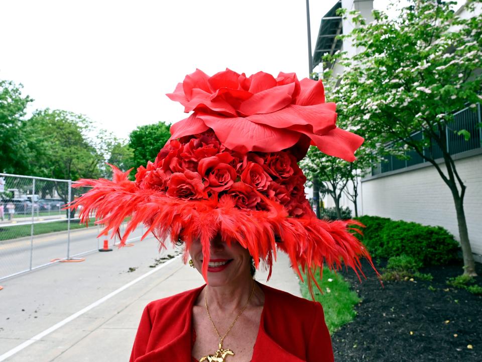 A red floral hat with feathers at the 2023 Kentucky Derby.