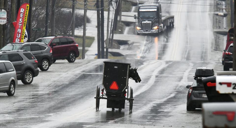 An Amish buggy travels south on Pennsylvania Route 77 through Spartansburg in northeastern Crawford County on March 6.