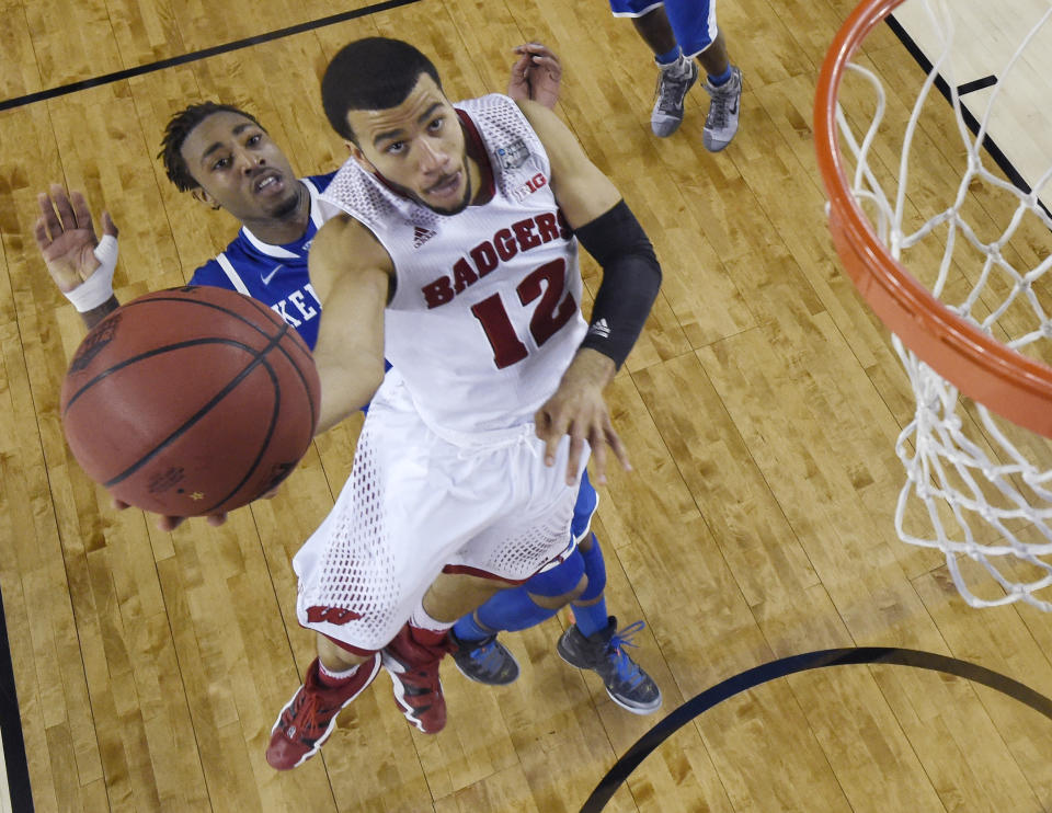 Wisconsin guard Traevon Jackson (12) drives to the basket past Kentucky guard James Young during the second half of an NCAA Final Four tournament college basketball semifinal game Saturday, April 5, 2014, in Arlington, Texas. Kentucky won 74-73. (AP Photo/Chris Steppig, pool)