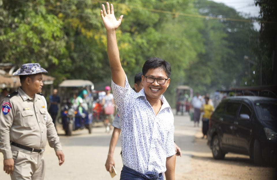 Reuters journalist Wa Lone waves as he walks out from Insein Prison after being released in Yangon, Myanmar Tuesday, May 7, 2019. The chief of the prison said two Reuters journalists who were imprisoned for breaking the country's Officials Secrets Act have been released. (AP Photo/Thein Zaw)