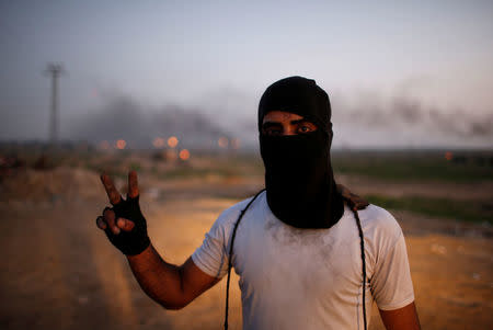A Palestinian protester, nicknamed "the man with the sling shooter", gestures as he poses for a photograph at the scene of clashes with Israeli troops near the border with Israel, east of Gaza City, January 12, 2018. "I am not affiliated with factions. I affiliate with Jerusalem. I know one thing, the one who is blockading me in Gaza, the one who prevented me from going to pursue my dream outside Gaza is standing behind that fence, the Israeli occupation soldiers," he said. REUTERS/Mohammed Salem