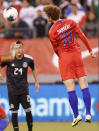In this photo taken Sept. 6, 2019, United States forward Josh Sargent, right, goes airborne while passing the ball to a teammate in the second half of an international friendly soccer match against Mexico in East Rutherford, N.J. After scoring his first goal of the season for Werder Bermen with a spectacular shot, 19-year-old Sargent hopes to play for the United States in his hometown during Tuesday's exhibition against Uruguay at Busch Stadium. (AP Photo/Kathy Willens)