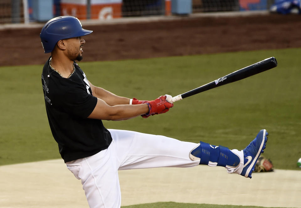 Los Angeles Dodgers' Mookie Betts watches a fly ball during batting practice, Tuesday, Sept. 29, 2020, at Dodger Stadium in Los Angeles, ahead of Wednesday's Game 1 of a National League wild-card baseball series against the Milwaukee Brewers. (AP Photo/Chris Pizzello)