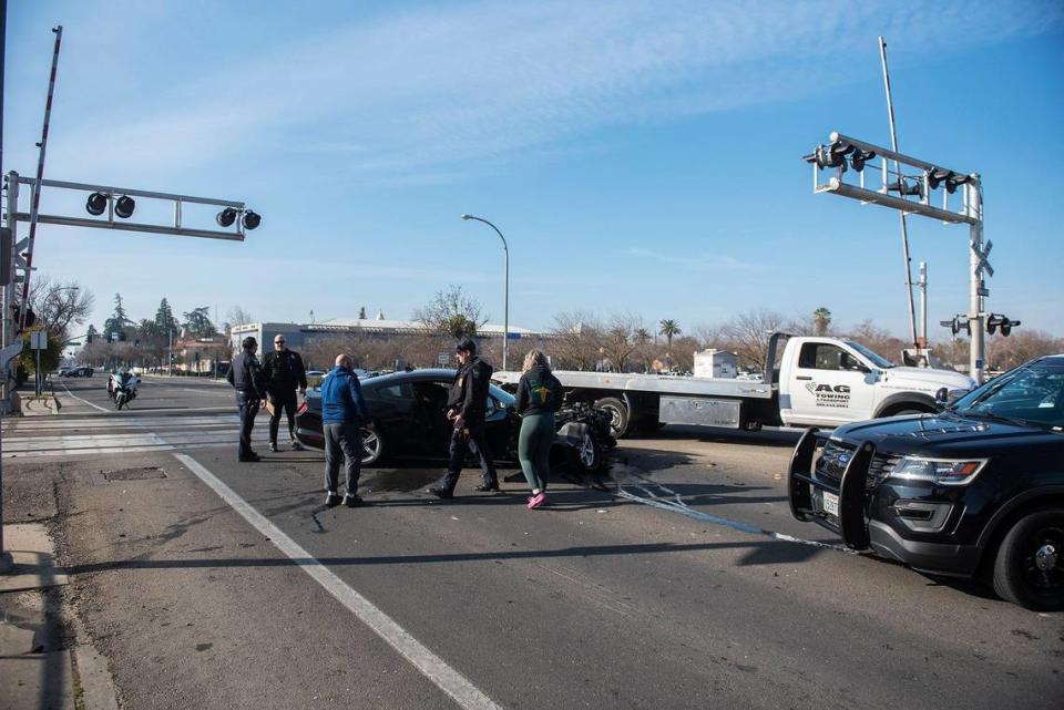 Police respond to the scene of a collision involving a vehicle and train on M Street in Merced, Calif., on Wednesday, Feb. 1, 2023. According to police, the 65-year-old driver was not injured when the vehicle rolled forward and collided with the passing freight train.