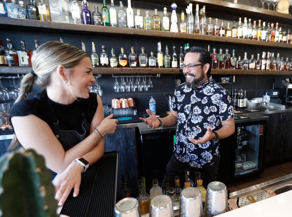 West Table bartender Rylie McCrary and Director of Operations Cousin Morin talk behind the bar at the popular business. Both mix and serve the Chilton Cocktail that has Lubbock origins and has become an often ordered drink throughout Lubbock area.