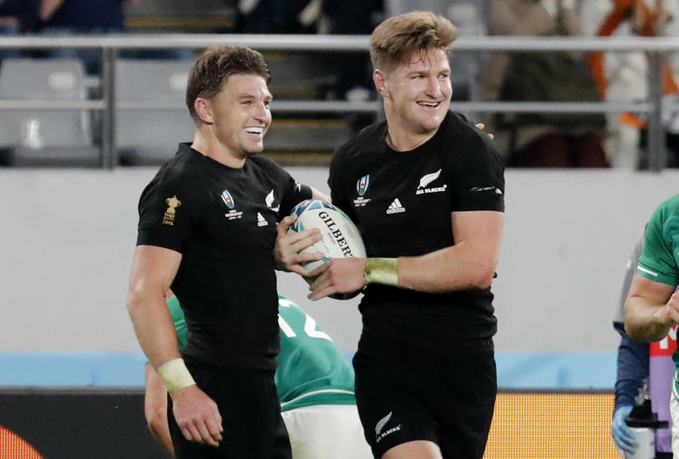 New Zealand's Jordie Barrett, right, and his brother Beauden Barrett celebrate after Jordie's try against Ireland during the Rugby World Cup quarterfinal match at Tokyo Stadium in Tokyo, Japan, Saturday, Oct. 19, 2019. (AP Photo/Eugene Hoshiko)