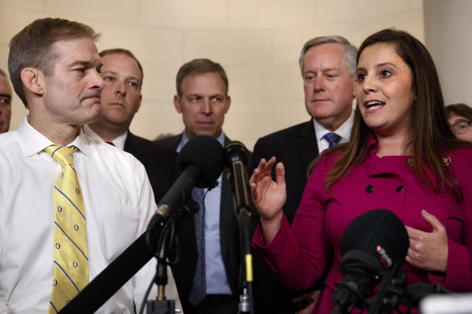 Rep. Jim Jordan, R-Ohio, left, listens as Rep. Elise Stefanik, R-N.Y., right, speaks to the media with other Republicans after former U.S. Ambassador to Ukraine Marie Yovanovitch testified to the House Intelligence Committee, Friday, Nov. 15, 2019, on Capitol Hill in Washington, in the second public impeachment hearing on President Donald Trump's efforts to tie U.S. aid for Ukraine to investigations of his political opponents. Left of Stefanik is Rep. Mark Meadows, R-N.C. (AP Photo/Jacquelyn Martin)