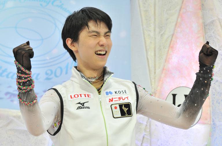 Japan's Yuzuru Hanyu reacts as he celebrates his first place following his performance in the men's free skating competition at the world figure skating championships in Saitama, on March 28, 2014