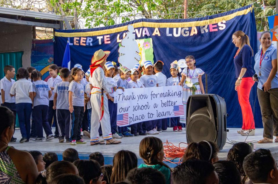 Children in Tegucigalpa, Honduras, celebrate the installation of a library as part of the Chispa Project.