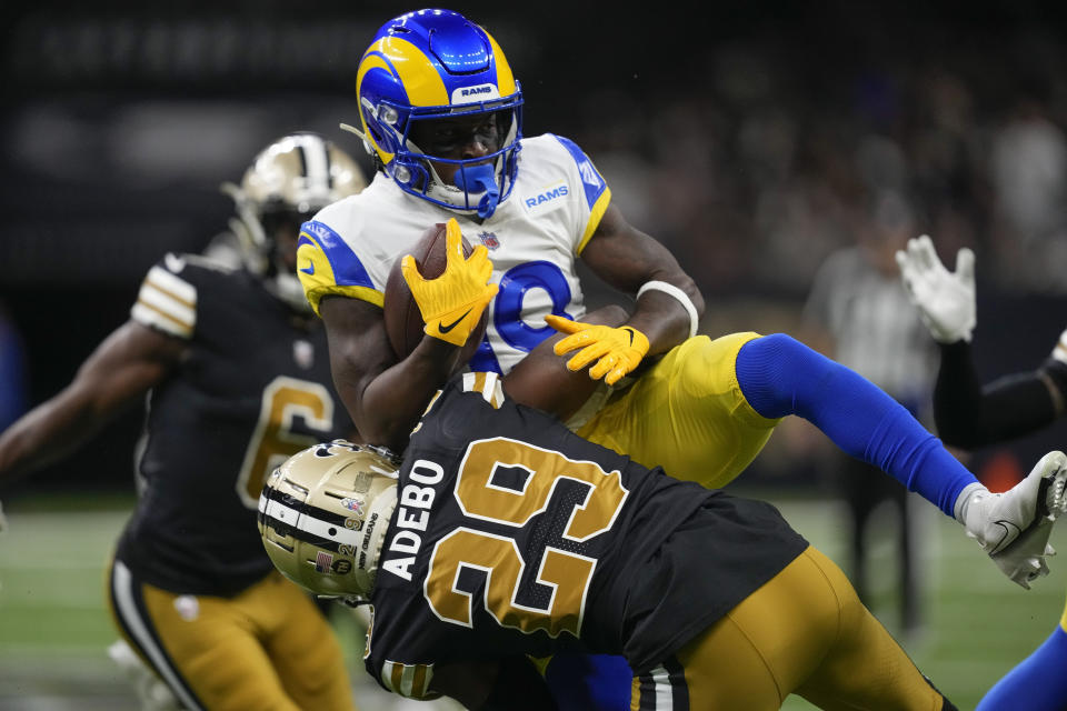 New Orleans Saints cornerback Paulson Adebo (29) stops Los Angeles Rams wide receiver Brandon Powell, top, in the first half of an NFL football game in New Orleans, Sunday, Nov. 20, 2022. (AP Photo/Gerald Herbert)