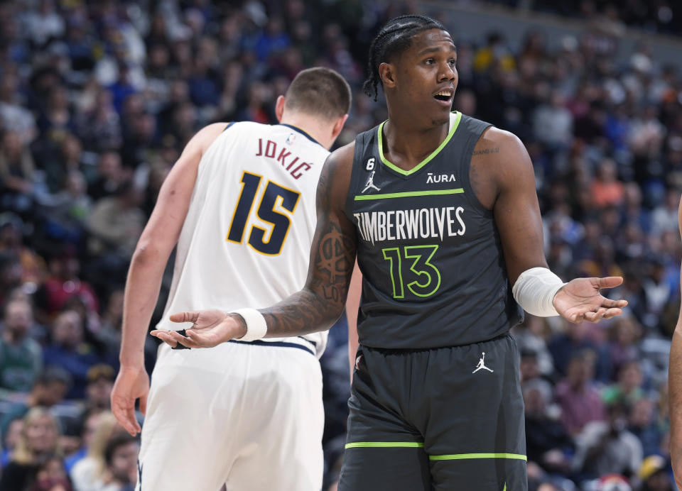 Minnesota Timberwolves forward Nathan Knight, front, argues after he was called for fouling Denver Nuggets center Nikola Jokic during the second half of an NBA basketball game Wednesday, Jan. 18, 2023, in Denver. (AP Photo/David Zalubowski)