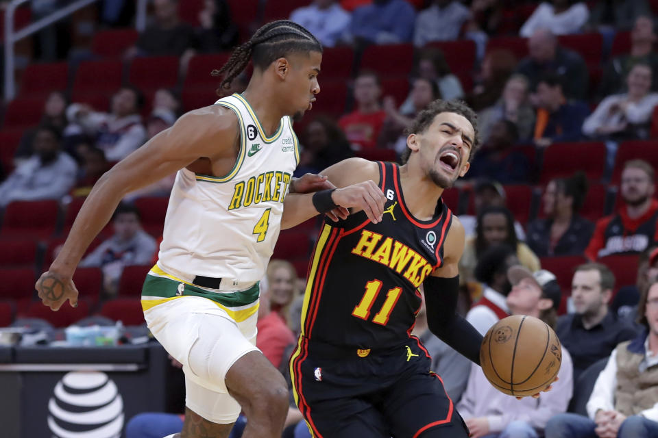 Atlanta Hawks guard Trae Young (11) reacts as he drives around Houston Rockets guard Jalen Green (4) during the first half of an NBA basketball game Friday, Nov. 25, 2022, in Houston. (AP Photo/Michael Wyke)