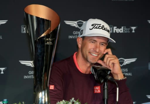 Adam Scott sits beside the trophy after his two-shot win in the Genesis Invitational at The Riviera Country Club on Sunday