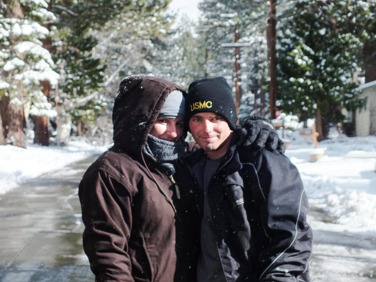 A picture of katie and her husband in winter clothes in Tahoe with snowy background