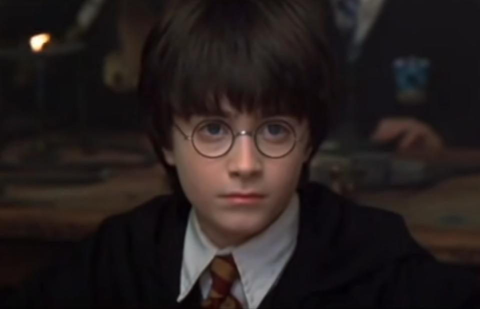 Daniel Radcliffe as Harry Potter sits and listens to a lecture during a Hogwarts class
