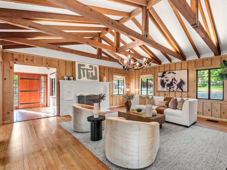 A living room covered in exposed wood