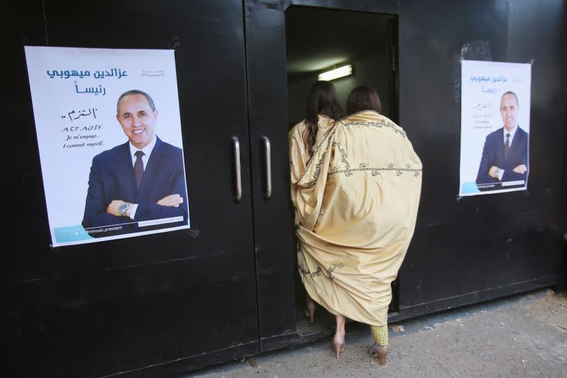 FILE PHOTO: Supporters of Algerian presidential candidate Azzedine Mihoubi enter to attend his campaign rally in Algiers