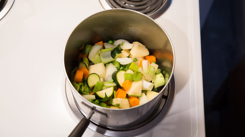 vegetables sauteing in saucepan 