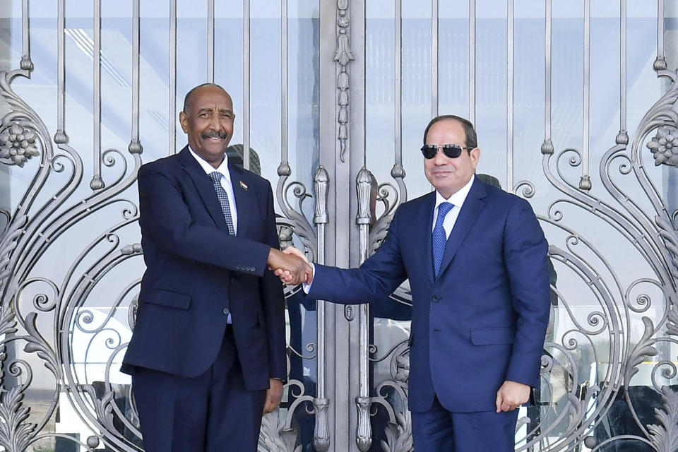 In this photo provided by Egypt's presidency media office, Egyptian President Abdel-Fattah el-Sissi, right, greets Sudan's army chief General Abdel Fattah al-Burhan at the Presidential palace in el-Alamein city, Egypt, Tuesday, Aug. 29, 2023. (Egyptian Presidency Media Office via AP)