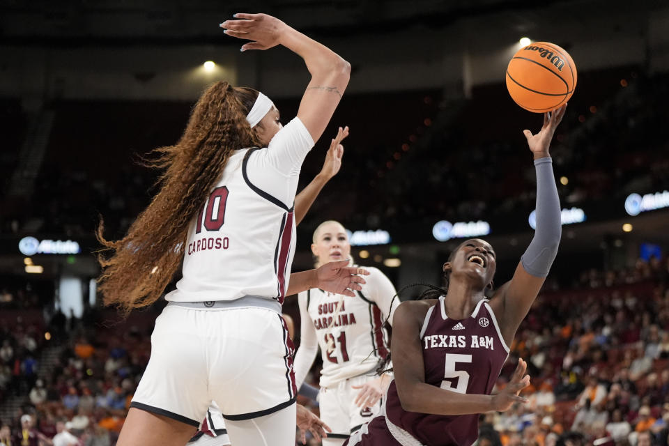 Texas A&M guard Aicha Coulibaly shoots over South Carolina center Kamilla Cardoso during the first half of an NCAA college basketball game at the Southeastern Conference women's tournament Friday, March 8, 2024, in Greenville, S.C. (AP Photo/Chris Carlson)