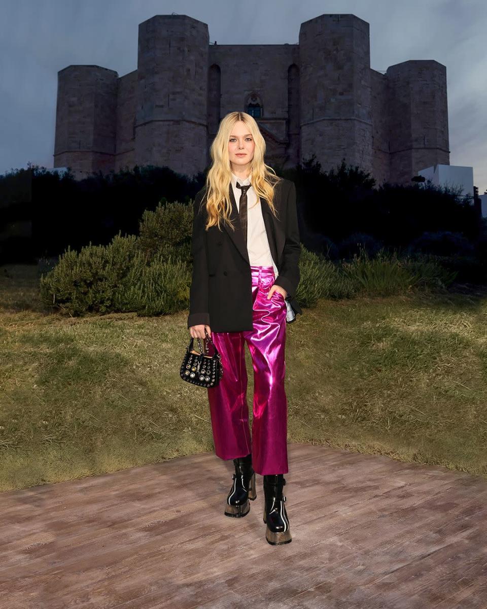 <p><strong>When:</strong> May 16</p><p><strong>Where: </strong>The Gucci Cosmogonie fashion show at Castel del Monte in Puglia, Italy.</p><p><strong>Wearing: </strong>A Gucci jacket with a white shirt, fuchsia pants, a black leather tie, black leather platform boots, and a black patent leather Jackie 1961 mini bag. </p><p><strong>Why: </strong>Fanning is giving a whole new meaning to party pants with this pair in laminated fuchsia.</p>