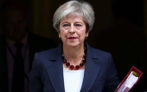 Theresa May leaves Downing Street to deliver her statement to the House of Commons - Credit: HANNAH MCKAY /Reuters