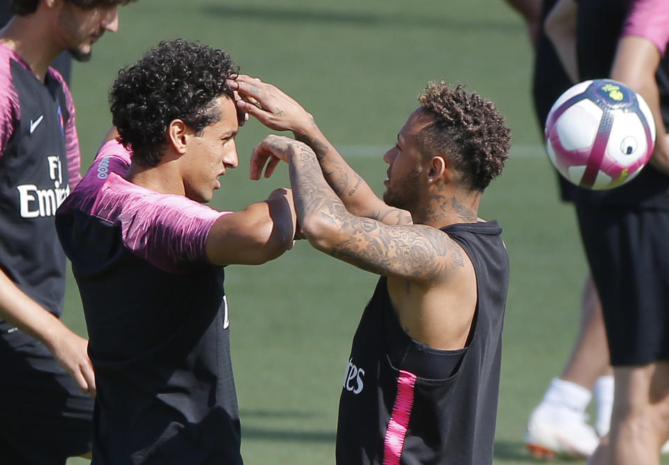 PSG's Marquinhos, left, and Neymar joke together during a training session at the Camp des Loges training center in Saint Germain en Laye, west of Paris, France, Saturday, Aug. 11, 2018. Paris Saint Germain will face Caen during their first match of the French League One session at Parc des Princes stadium on Sunday Aug. 12, 2018. (AP Photo/Michel Euler)