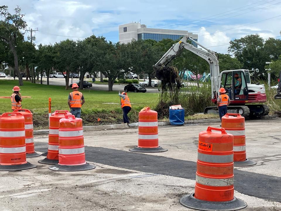 Workers clear a drainage area Wednesday afternoon within Brightline's Melbourne Avenue closure zone just east of the Crane Creek bridge.