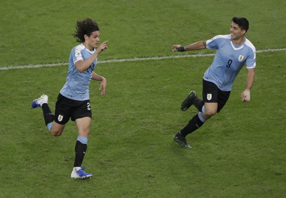 Uruguay's Edinson Cavani, left, celebrates with teammate Luis Suarez after scoring his side's first goal against Chile during a Copa America Group C soccer match at Maracana stadium in Rio de Janeiro, Brazil, Monday, June 24, 2019. (AP Photo/Eraldo Peres)