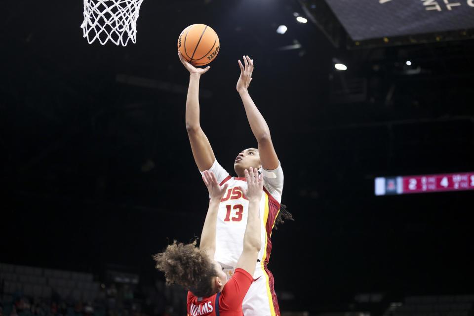 Southern California center Rayah Marshall (13) shoots over Arizona guard Jada Williams, bottom, during the second half of an NCAA college basketball game in the quarterfinal round of the Pac-12 tournament Thursday, March 7, 2024, in Las Vegas. (AP Photo/Ian Maule)