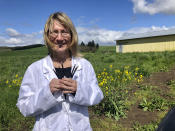 ADVANCE FOR PUBLICATION ON TUESDAY, JUNE 11, AND THEREAFTER - In this April 12, 2019, photo, Cyndi Michael, a former medical marijuana grower, holds the last syringes of cannabis tincture she will process for sale in Rickreall, Ore., after deciding to no longer grow medical marijuana. The number of medical marijuana growers participating in Oregon's 20-year-old medical cannabis program has plummeted after the state legalized cannabis for all adults. Michael, who once grew for eight patients, could no longer make ends meet and also lost her business selling supplies to other medical marijuana growers. (AP Photo/Gillian Flaccus)