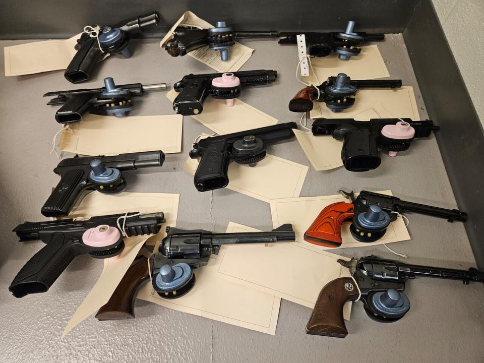 This photo shows a number of guns that were seized by police as part of an investigation that was started after a traffic stop in Waterloo Friday night.