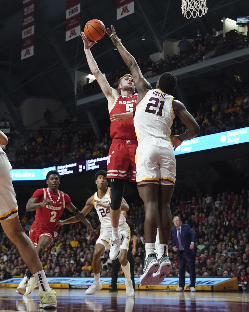 Wisconsin forward Tyler Wahl (5) shoots over Minnesota forward Pharrel Payne (21) during the second half of an NCAA college basketball game Tuesday, Jan. 23, 2024, in Minneapolis. (AP Photo/Craig Lassig)