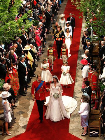 <p>Richard Pohle-WPA Pool/Getty</p> Prince William and Kate Middleton walking down the aisle