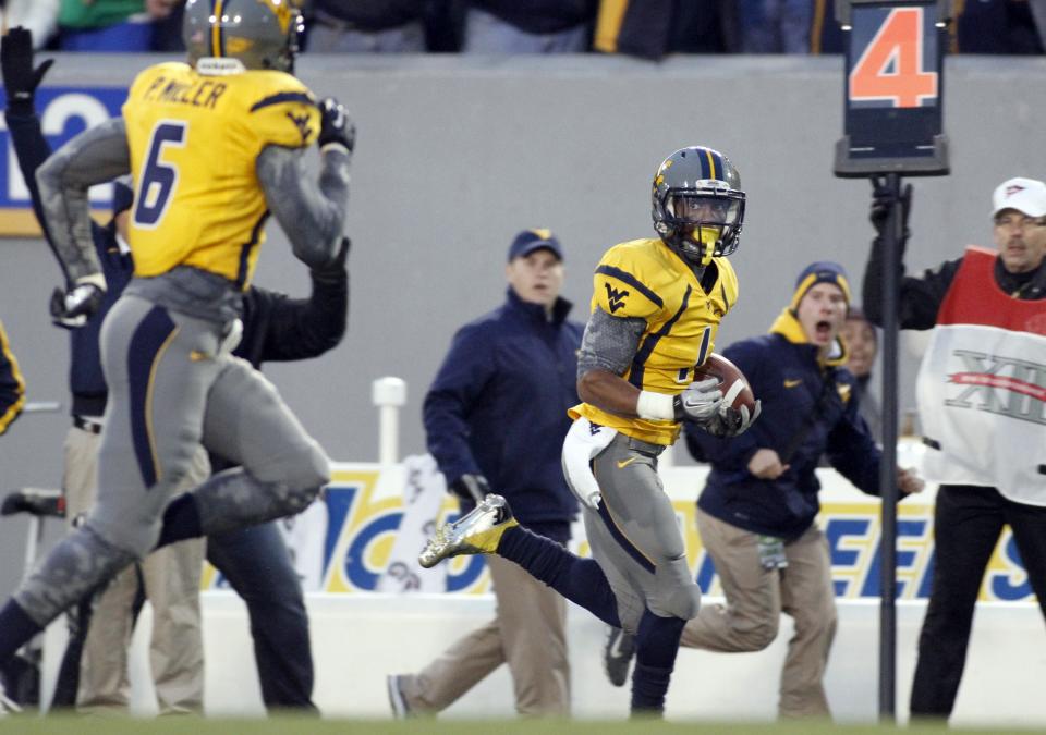 Tavon Austin #1 of the West Virginia Mountaineers runs back a punt for a touchdown in the second half of the game against the TCU Horned Frogs during the game on November 3, 2012 at Mountaineer Field in Morgantown, West Virginia. TCU defeated WVU in two overtimes 39-38. (Photo by Justin K. Aller/Getty Images)